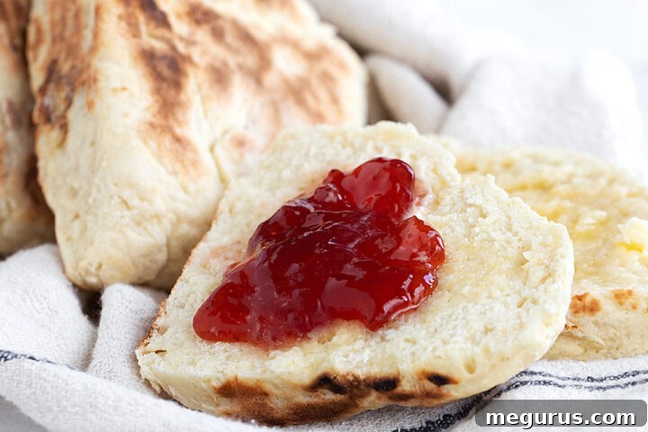 Irish soda farls on tea towel split with jam.