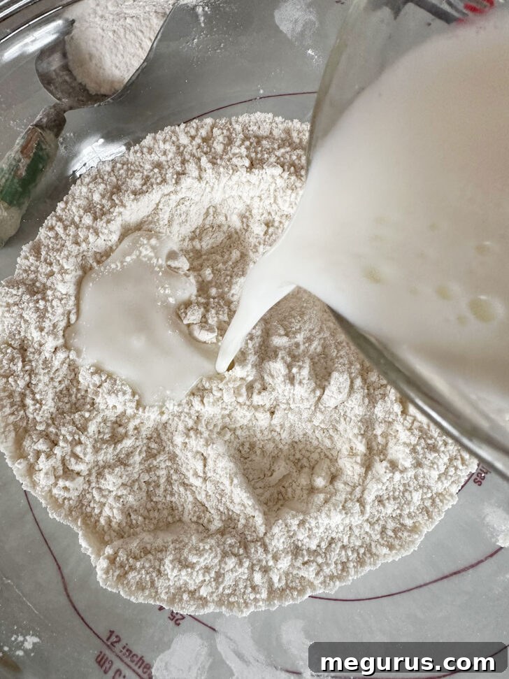Adding buttermilk to dough.