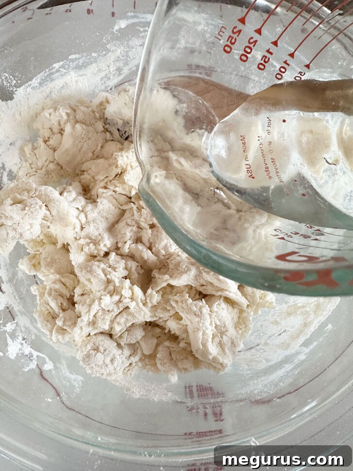 Adding a bit of water to the dough.