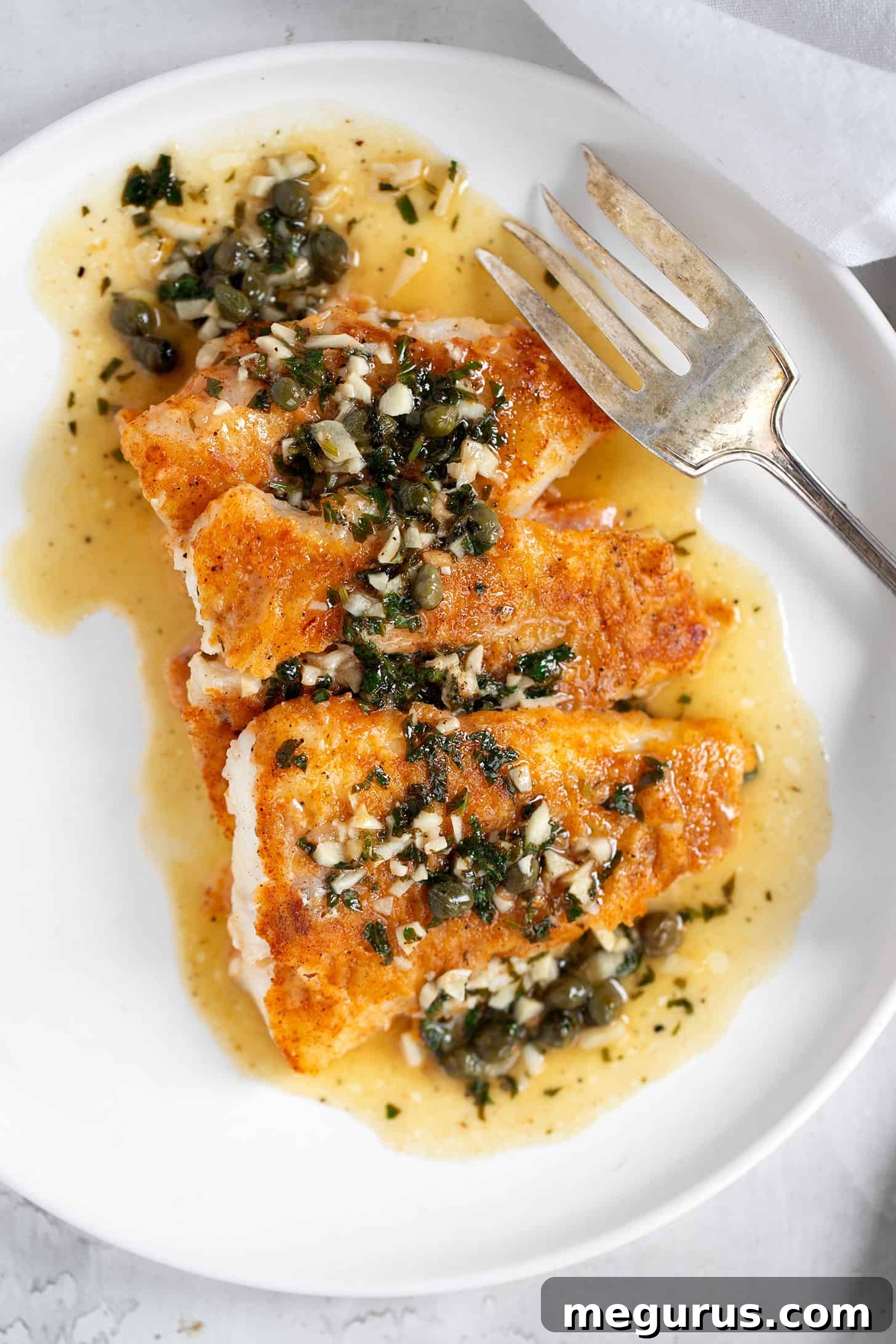 Cod Piccata on plate with fork.