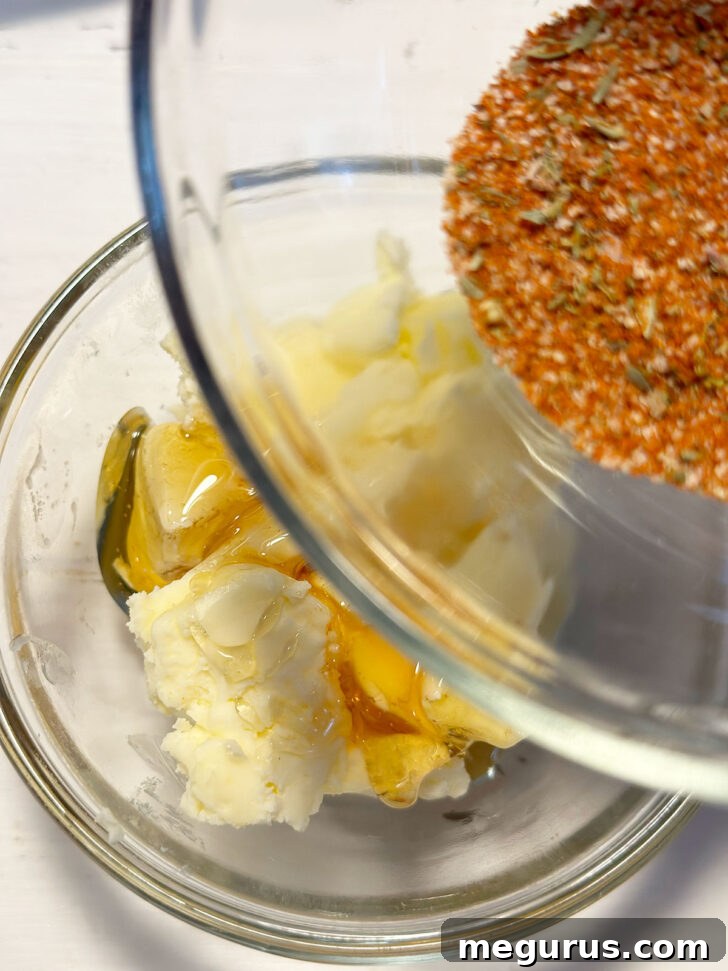 Mixing together softened butter, honey, and Cajun spice mix for the honey butter.
