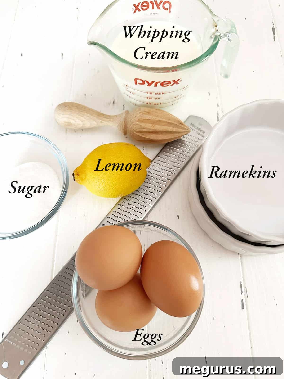 Ingredients to make lemon creme brulee laid out on a table.