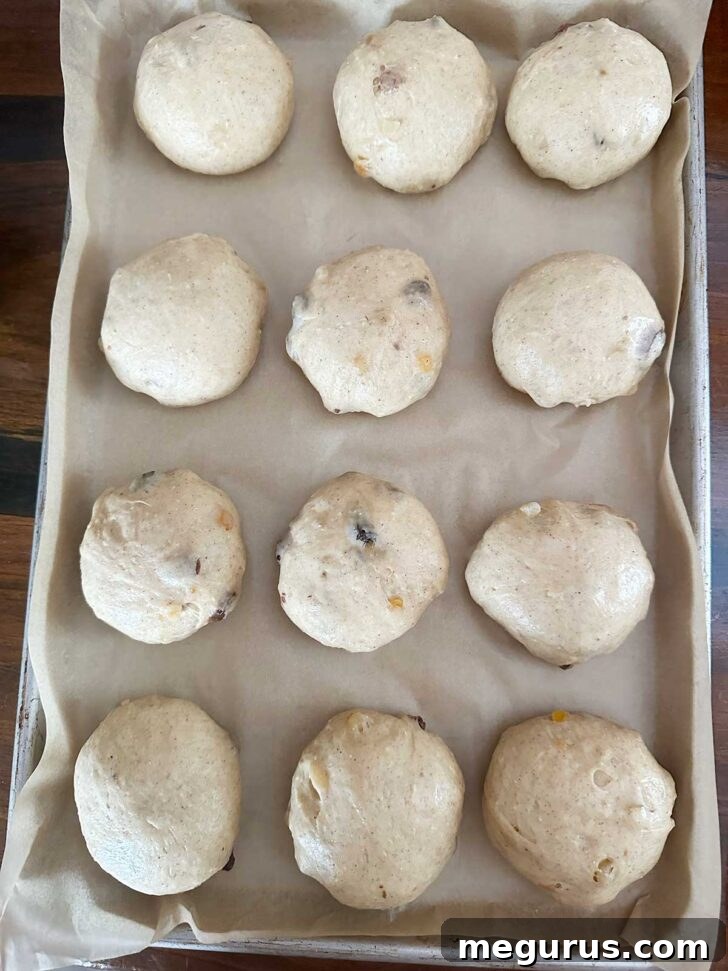 12 dough balls on a parchment-lined baking sheet.