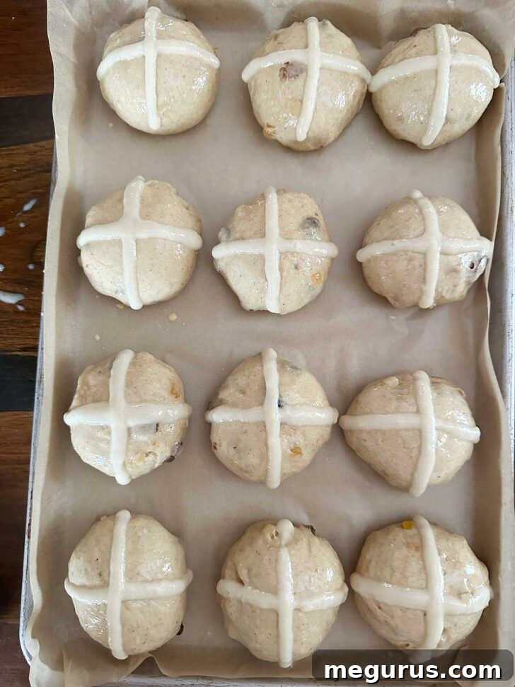 Buns after piping the flour crosses on top.