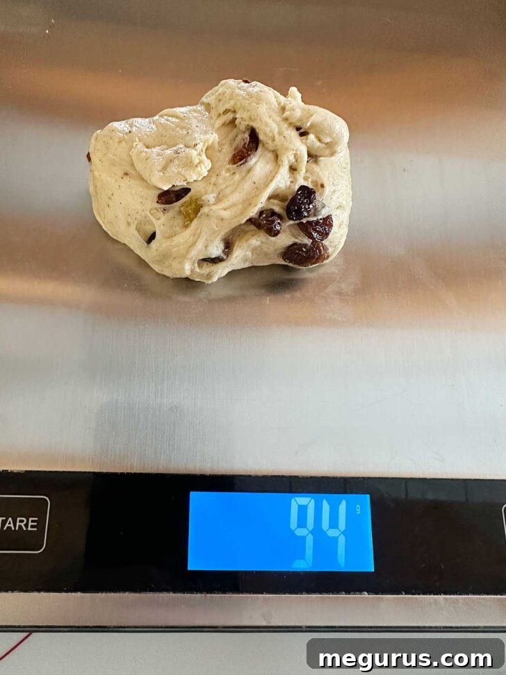Weighing out the dough balls on a kitchen scale.