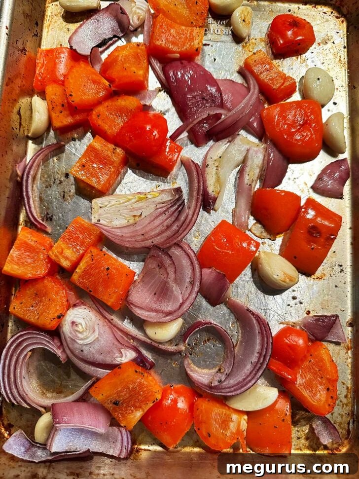 Roasted vegetables on a sheet pan, slightly caramelized.
