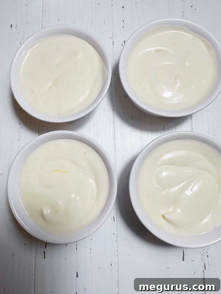 Lemon curd puddings after the extra lemon curd has been lightly swirled in, creating beautiful marbled patterns and pockets of flavor.