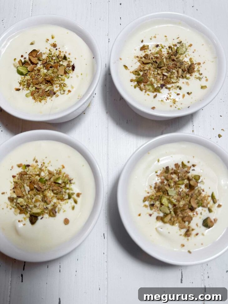 Lemon curd pudding in a ramekin, elegantly topped with finely chopped pistachios, showcasing its vibrant presentation.