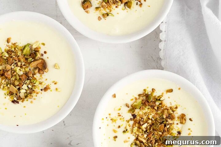 Lemon curd pudding in ramekins with pistachios on top.