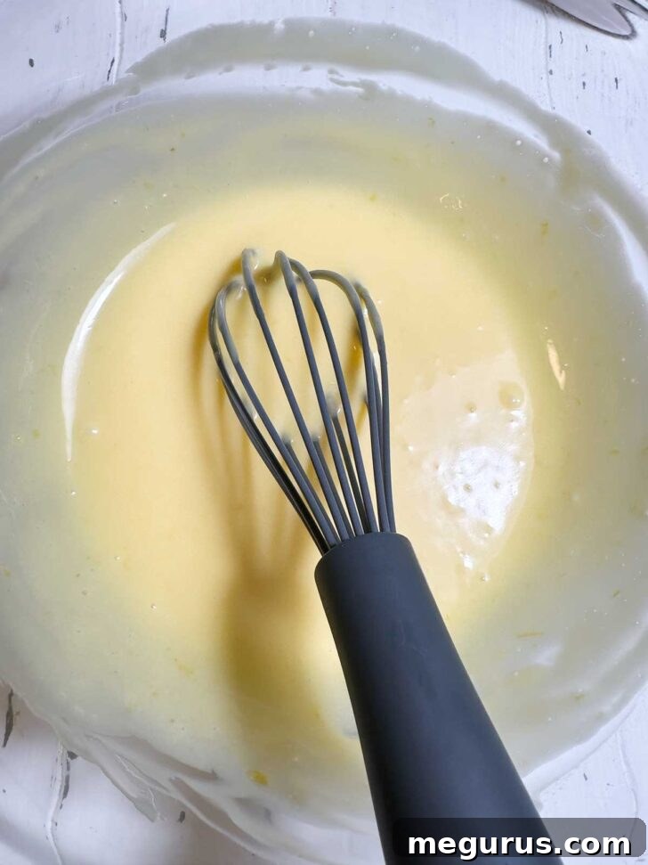 The lemon curd and crème frâiche mixture after being whisked until smooth, forming the creamy base for the pudding.