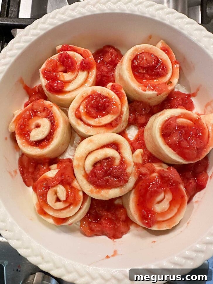 Rolls and extra strawberry mixture in baking pan.