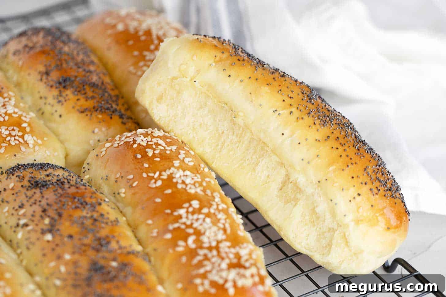 Freshly baked fluffy brioche hot dog buns on a cooling rack, ready to serve.