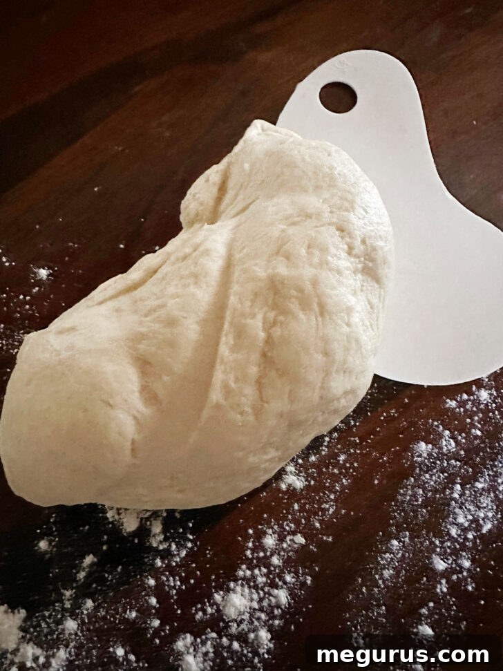 Finished sticky brioche dough on a lightly floured work surface.