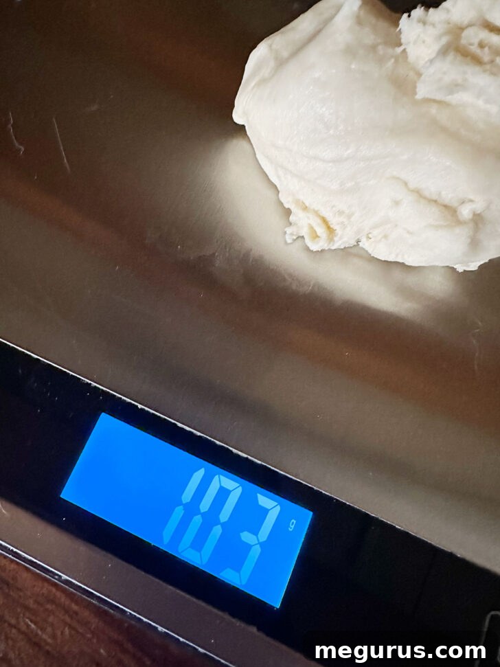 Precisely weighing individual portions of brioche dough.