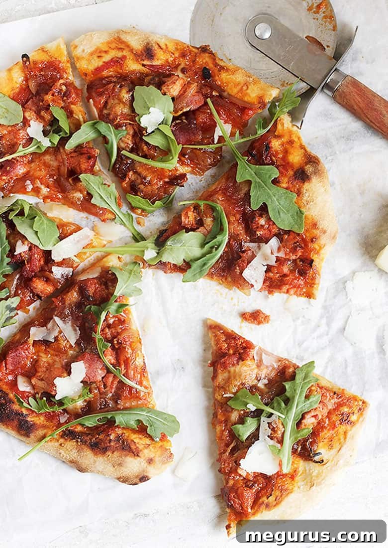 chorizo and manchego cheese pizza sliced on parchment