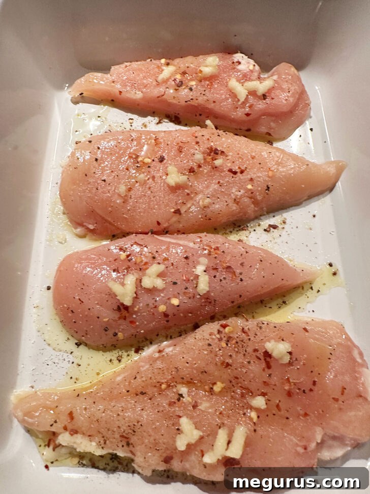Chicken breasts in baking dish.