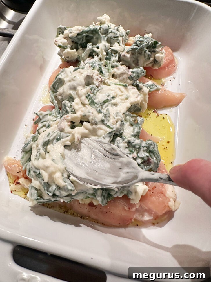 Cream cheese mixture spooned on top of chicken.