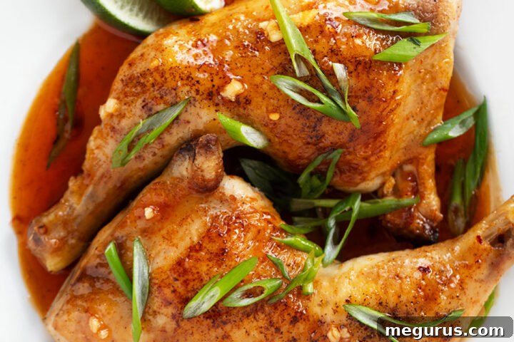 Hot honey chicken legs on plate with onion and lime.