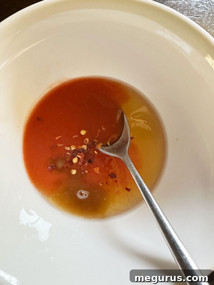 Ingredients for hot honey sauce mixed in a small bowl.