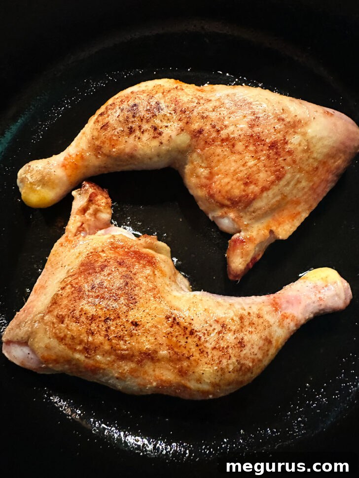 Cooked chicken legs removed from the oven, resting on a serving platter.