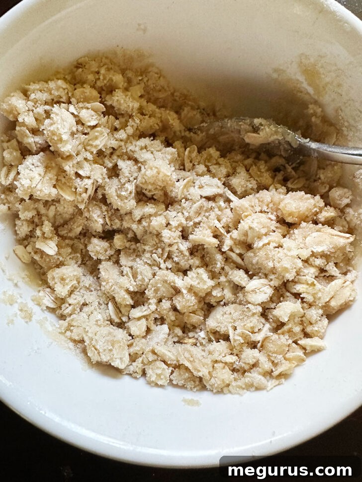 Crisp topping ingredients combined in a bowl with melted butter.