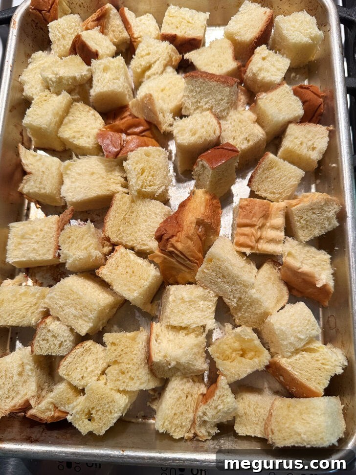 Cubed bread on a baking sheet, ready for drying in the oven