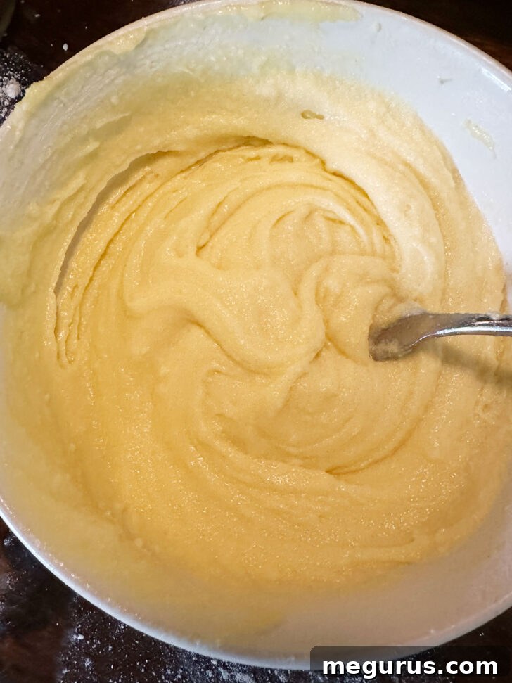 The fully mixed, smooth custard filling mixture in a bowl, before adding rhubarb.