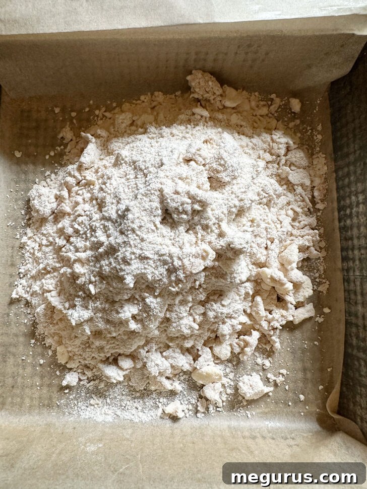 The majority of the crumb mixture transferred to a prepared 9x9 inch baking pan.