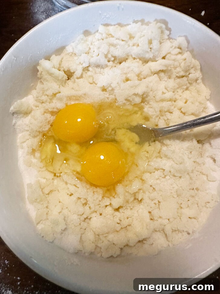 Eggs and vanilla being added to the filling mixture for a smooth consistency.