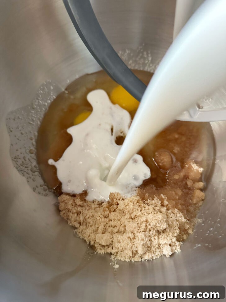 Adding buttermilk to the wet ingredients in a large mixing bowl.