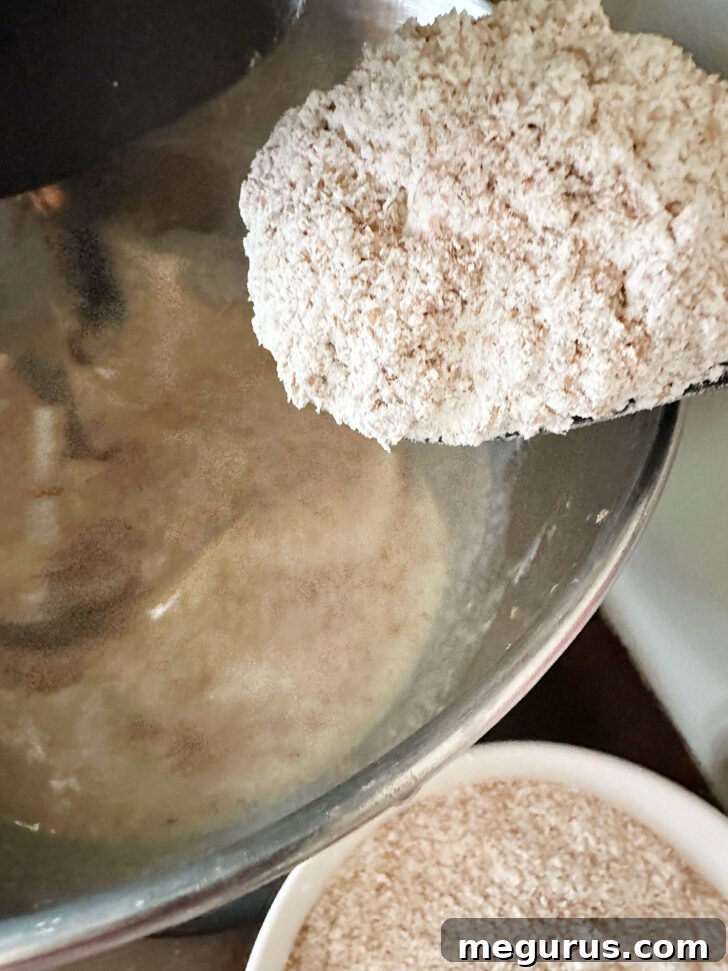 Incorporating the softened wheat bran mixture into the wet batter.