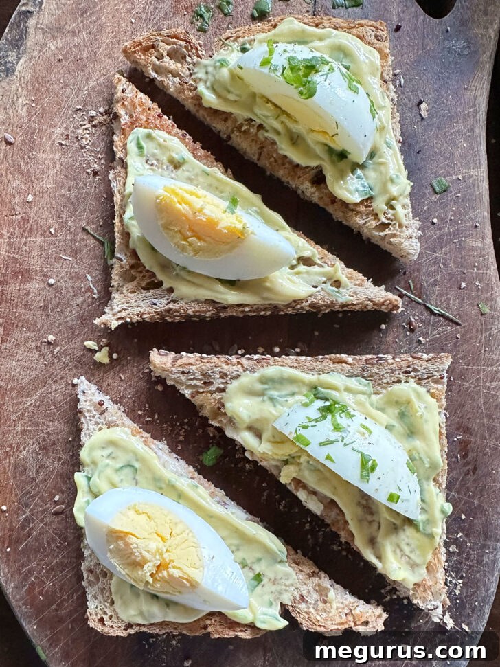 Assemble devilled egg sandwiches on cutting board.