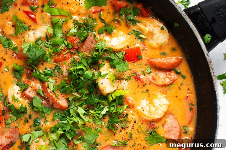 Cajun shrimp and sausage in skillet.