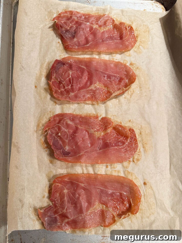 Crispy prosciutto on baking sheet after cooking.