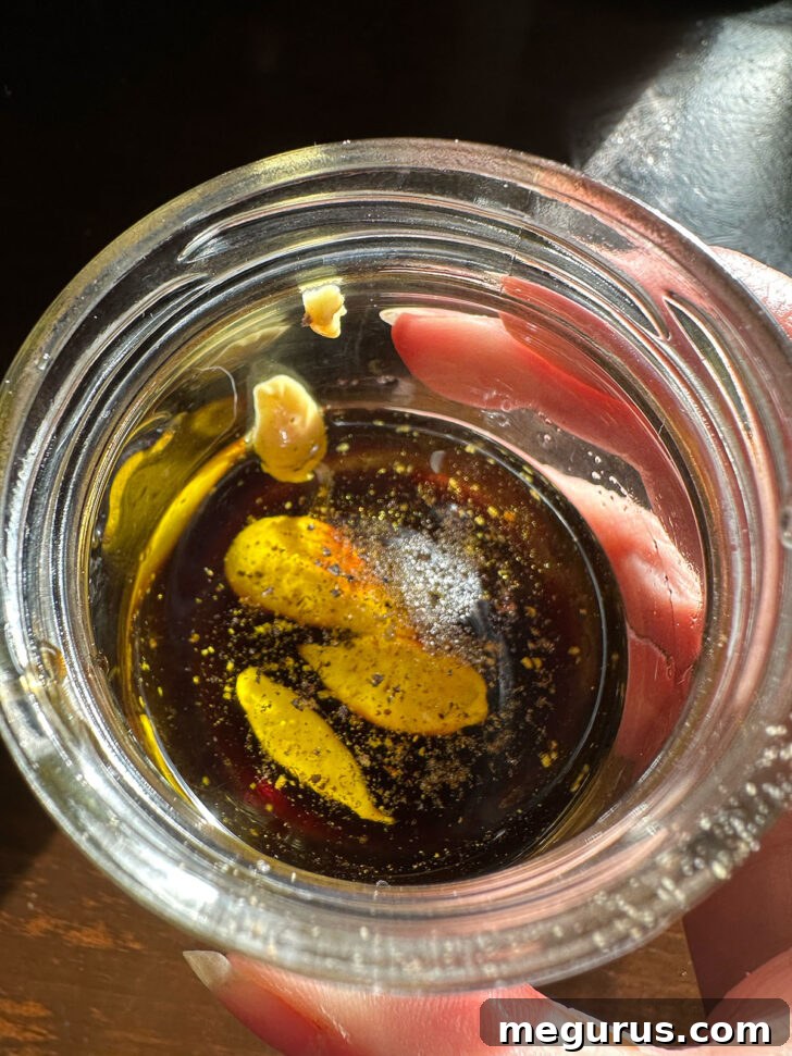 Balsamic dressing ingredients in small jar.