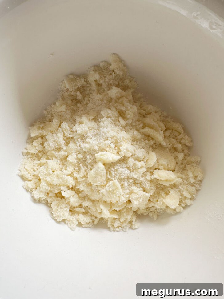 A small bowl containing the crumb topping mixture, showing the perfectly cut-in cold butter with flour and sugar.