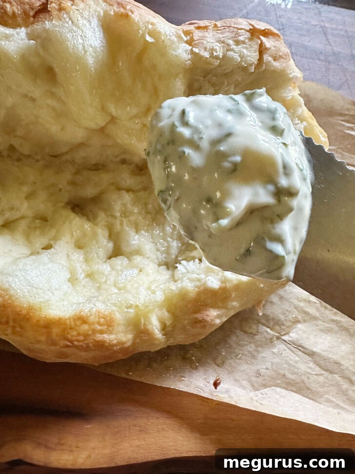 The inside of the pizza sandwich being generously spread with homemade basil mayo.