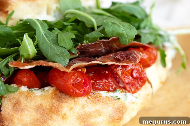 BLT pizza sandwich on parchment paper.