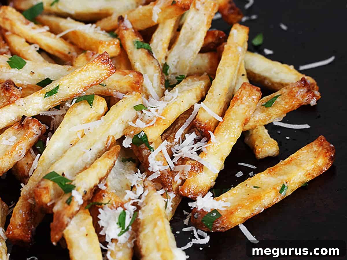 Crispy fries topped generously with creamy garlic aioli and grated Parmesan cheese, ready to be devoured.