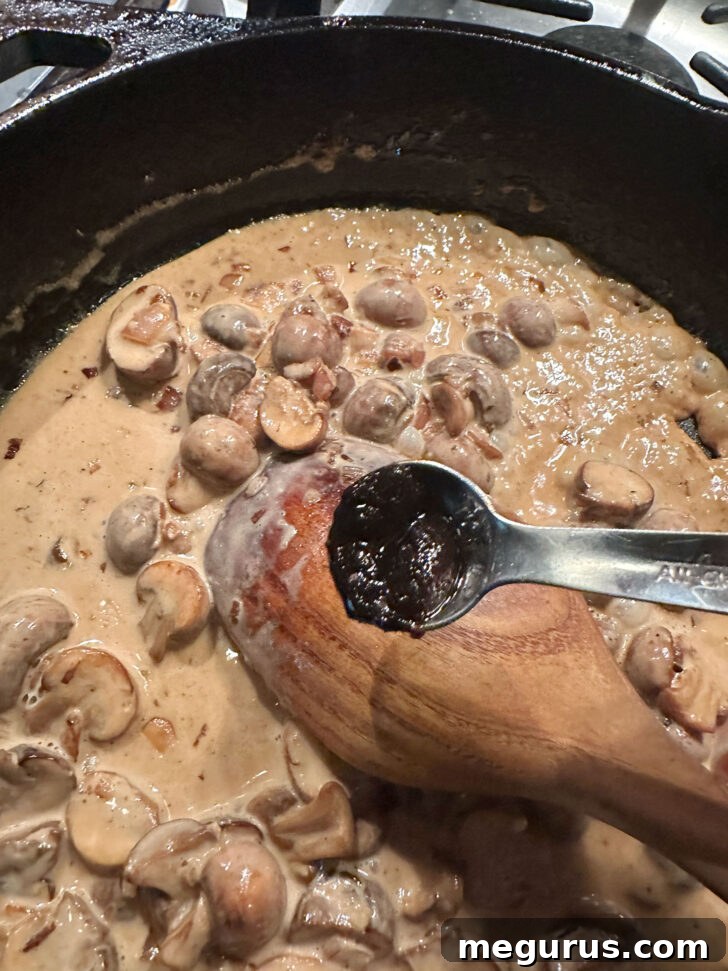 Adding concentrated beef base to the creamy mushroom sauce, deepening its savory flavor.