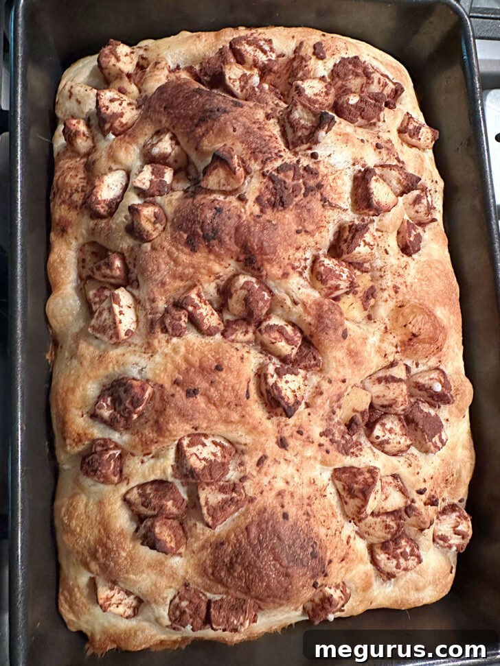 Baked Apple Fritter Focaccia, deep golden brown and bubbly, just out of the oven before glazing.