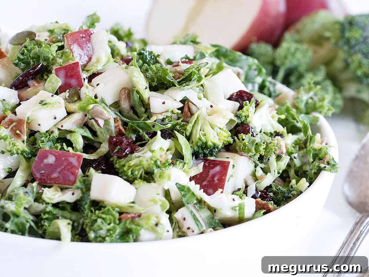 Fall kale salad with apple in white bowl