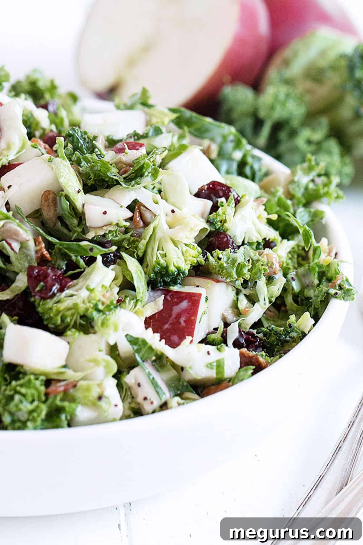 Fall kale salad with apple in white bowl