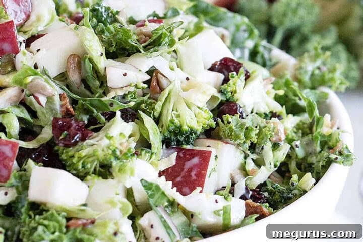 Fall kale salad with apple in white bowl