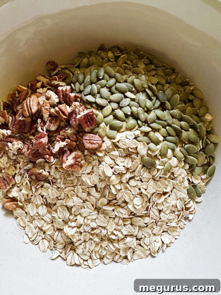 Pumpkin granola dry ingredients in bowl.