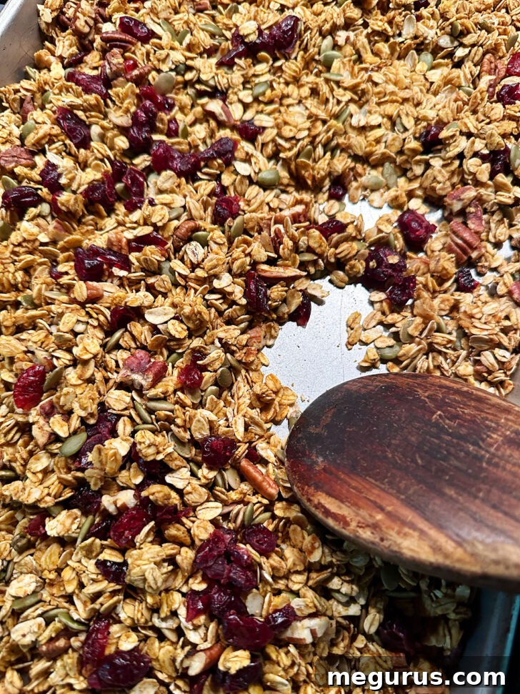 Stirring and cooling the granola after baking.
