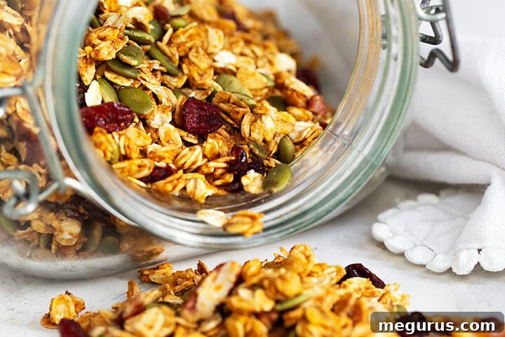 Pumpkin granola spilling out of jar.