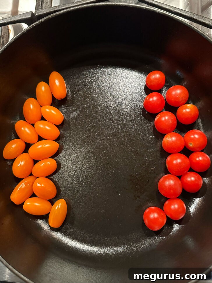 Adding cherry tomatoes to the skillet.