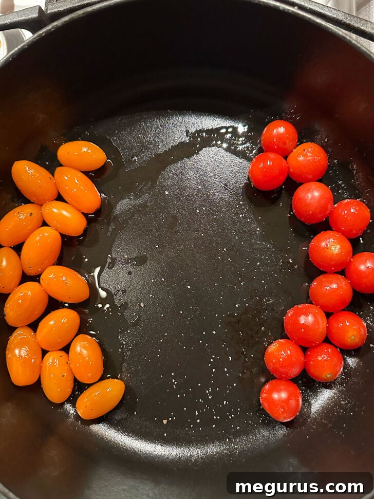 Cherry tomatoes in baking dish after a short time in the oven.