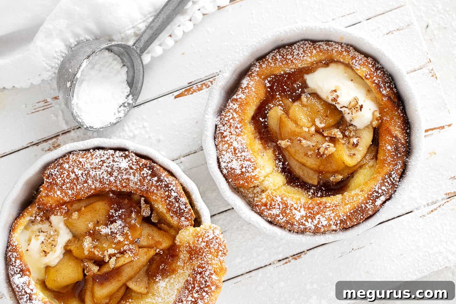 Individual Maple Apple Dutch Baby Pancakes in ramekins, ready to be served
